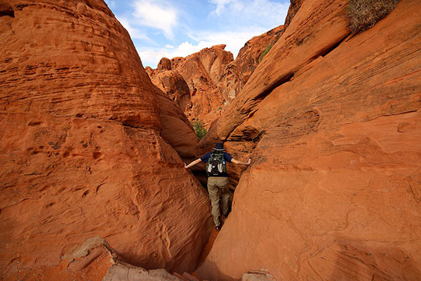 Bronwen climbing along a pathway at Mouse’s Tank in the Valley of Fire