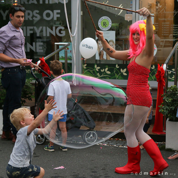 A young boy catches Miss Bubbles’ huge bubble at the Paddington Christmas Fair