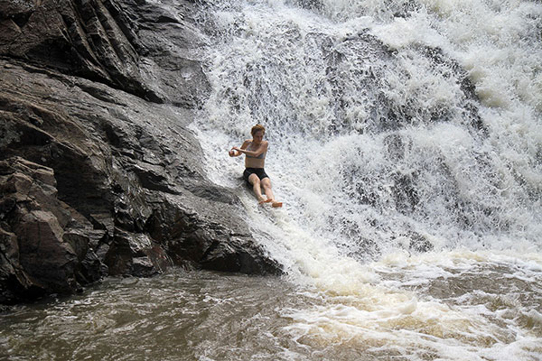 Bronwen slides down a waterfall