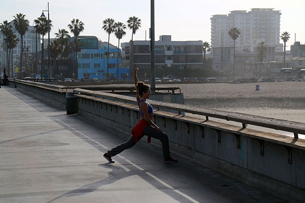 A woman exercies on Venice Beach
