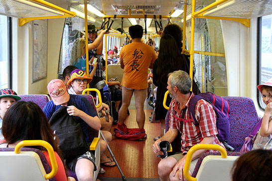 Passengers are bemused as pants come off for Brisbane “No Pants Subway Ride”