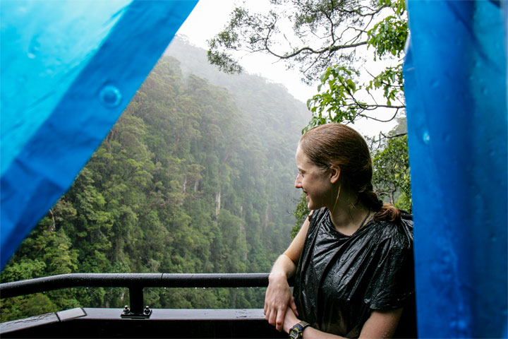 Bronwen overlooking Coomera Gorge in the rain, taken from underneath a poncho
