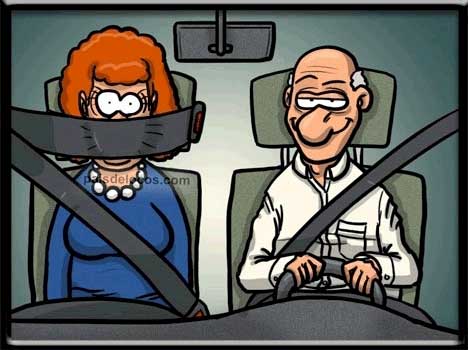 A man driving a car while a woman sits beside him, with her seatbelt across her mouth, preventing her from commenting.