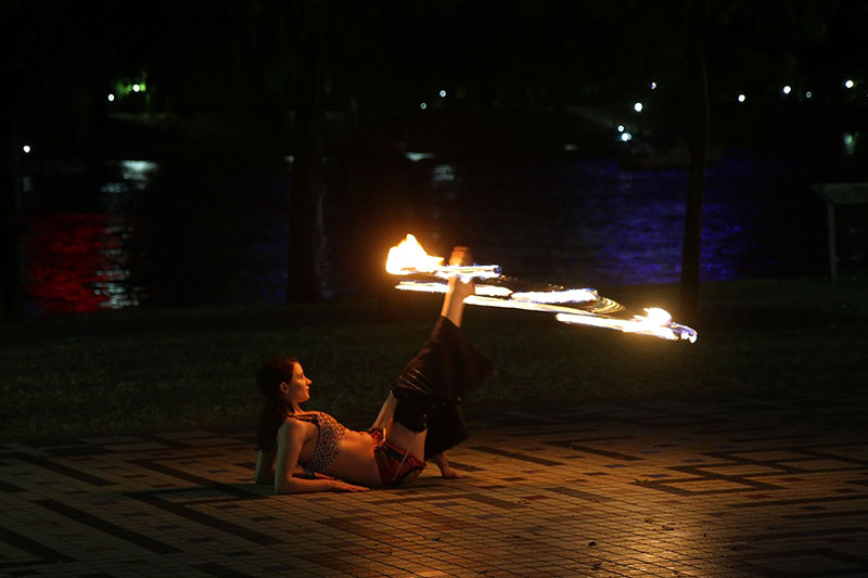 A girl plays with fire at Sunset Gathering