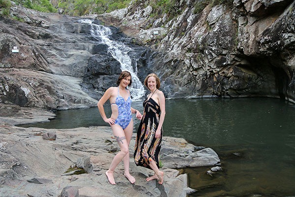 Shandina & Bronwen surprised to find a photographer is at their waterfall