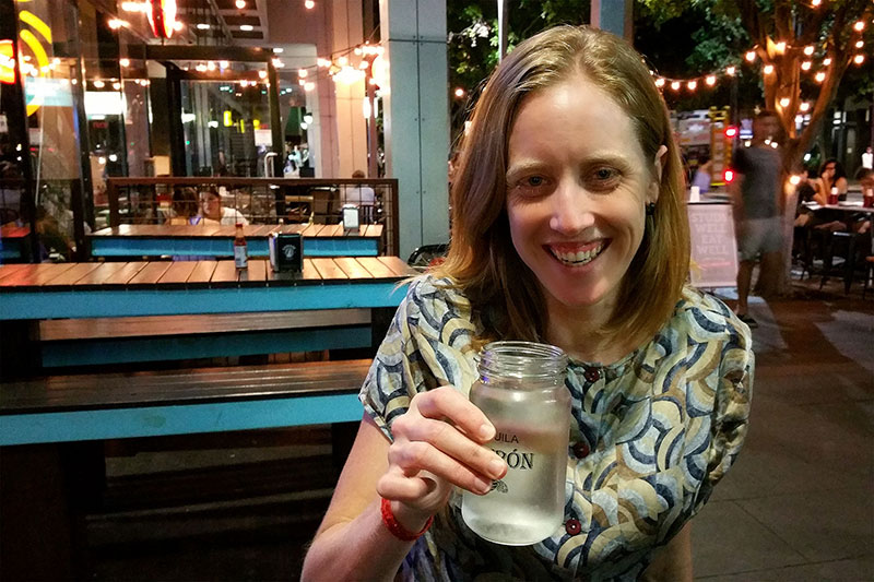 Bronwen drinking from a “classy” jar while awaiting her over-priced tacos