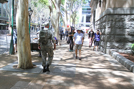 A soldier walks along a barricaded road