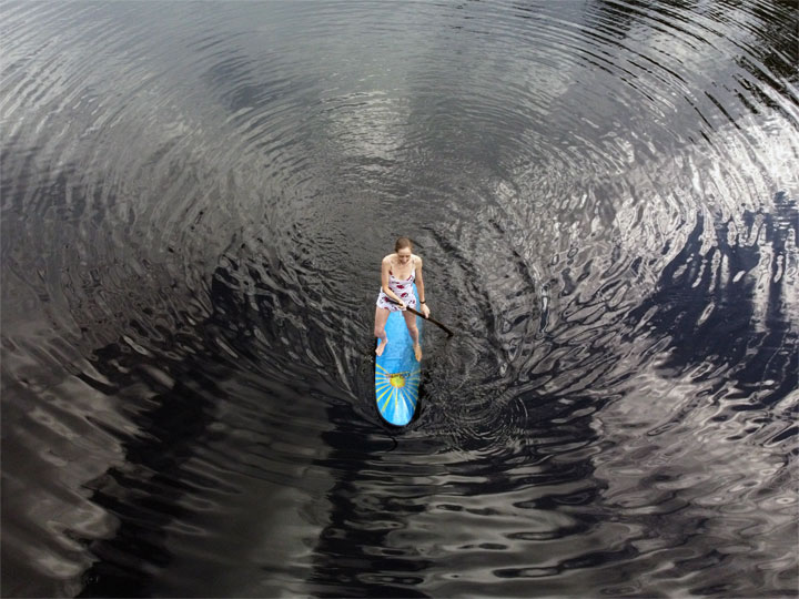 Bronwen trying to stand on a foam surfboard at Enoggera Reservoir