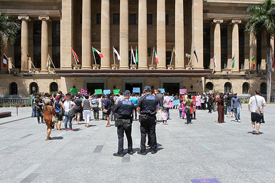 Police watch protesters outside City Hall