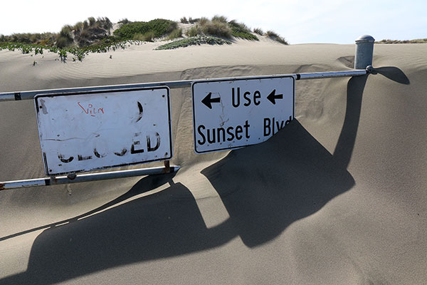 Sand engulfing a road