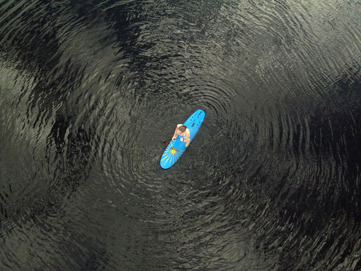 Bronwen trying to stand on a foam surfboard at Enoggera Reservoir