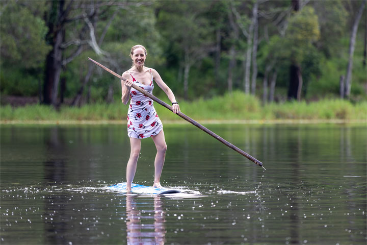 Bronwen trying to stand on a foam surfboard at Enoggera Reservoir