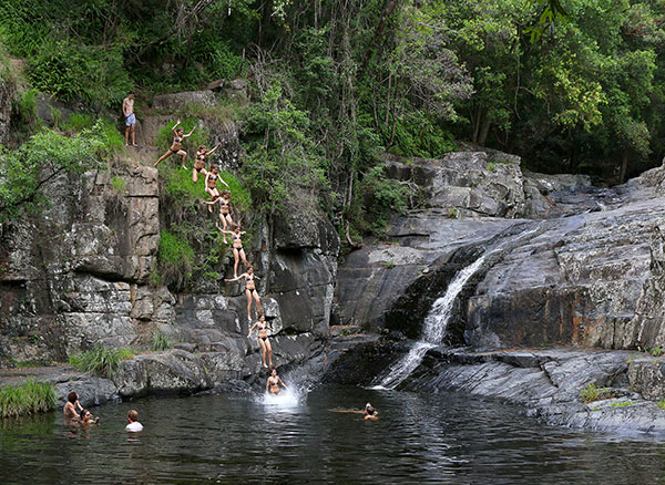 Jumping from rocks at Cedar Creek Falls