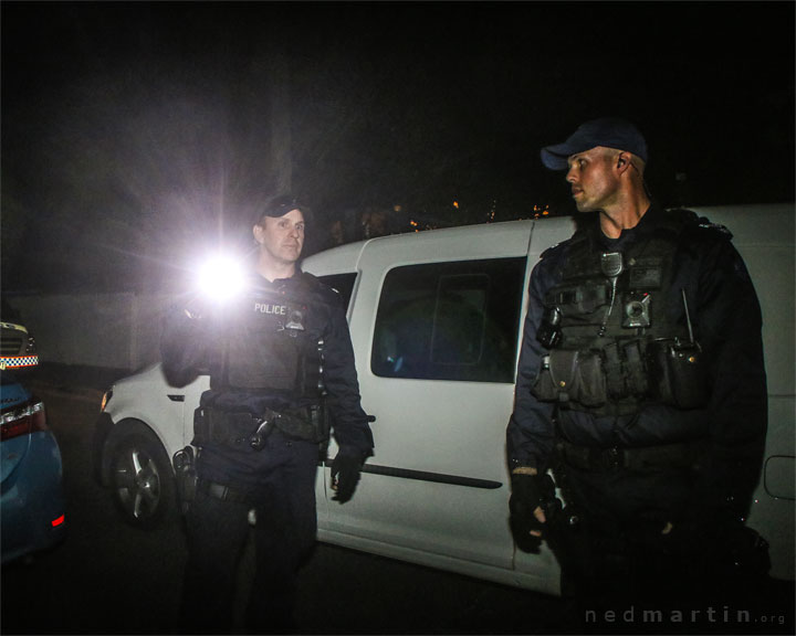 Police escort a food van into the compound