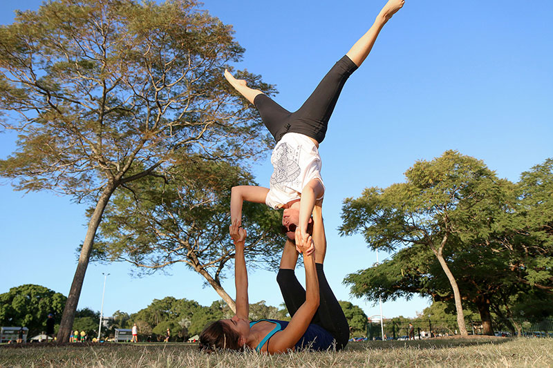 A woman balances on a woman