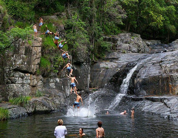 Jumping from rocks at Cedar Creek Falls