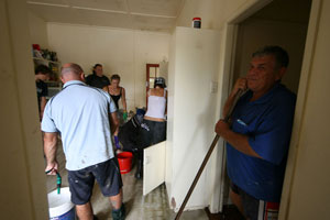 Volunteers cleaning the kitchen on the third day of clean-up