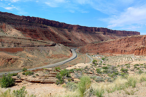 The road snakes through colourful cliffs