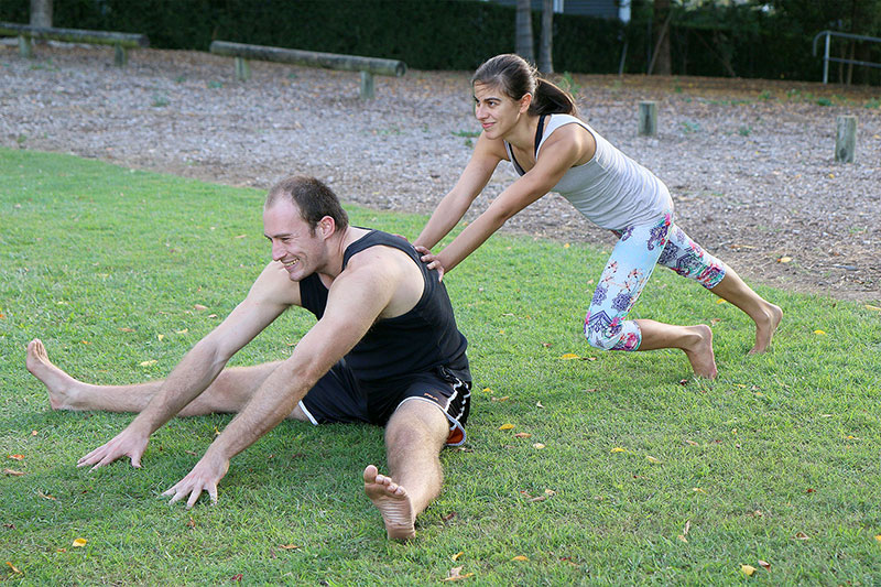 A woman tries to push-start a man