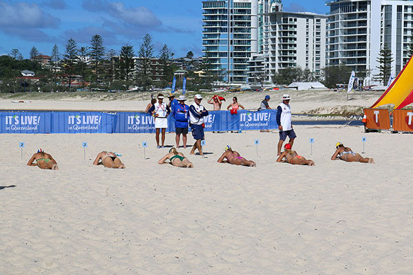 Women being inspected on their lying in the sun skills