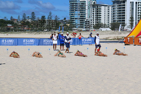 Women being inspected on their lying in the sun skills