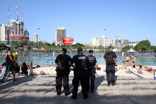 Police watching swimmers at the South Bank peeing pool