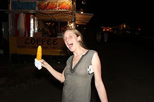 Bronwen delighted with her corn cob, The Amazing Woodford Folk Festival