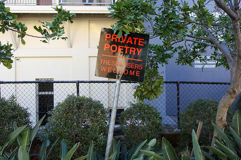 A sign near The Powerhouse: Private Poetry – Trespassers Welcome