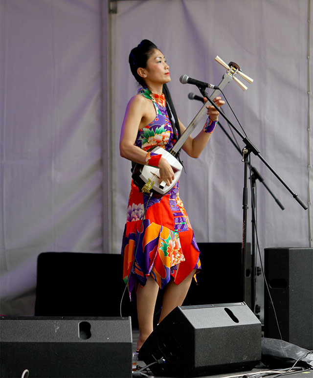 Noriko, from George and Noriko, playing a traditional, fretless three-string shamisen
