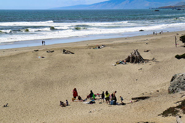 People hiding from the wind on a Californian beach