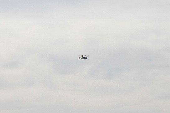 One of Obama’s strange-looking Osprey flies around in the background