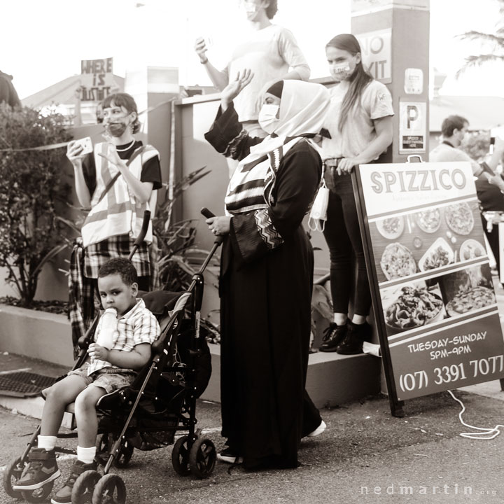 The mother waves to her husband