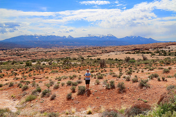 Ned in the desert, with snow-capped mountains in the background