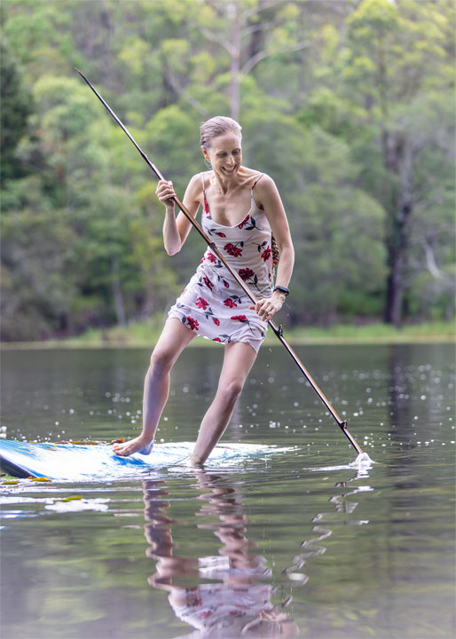 Bronwen trying to stand on a foam surfboard at Enoggera Reservoir