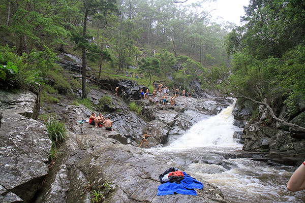 People spread out along the waterfall