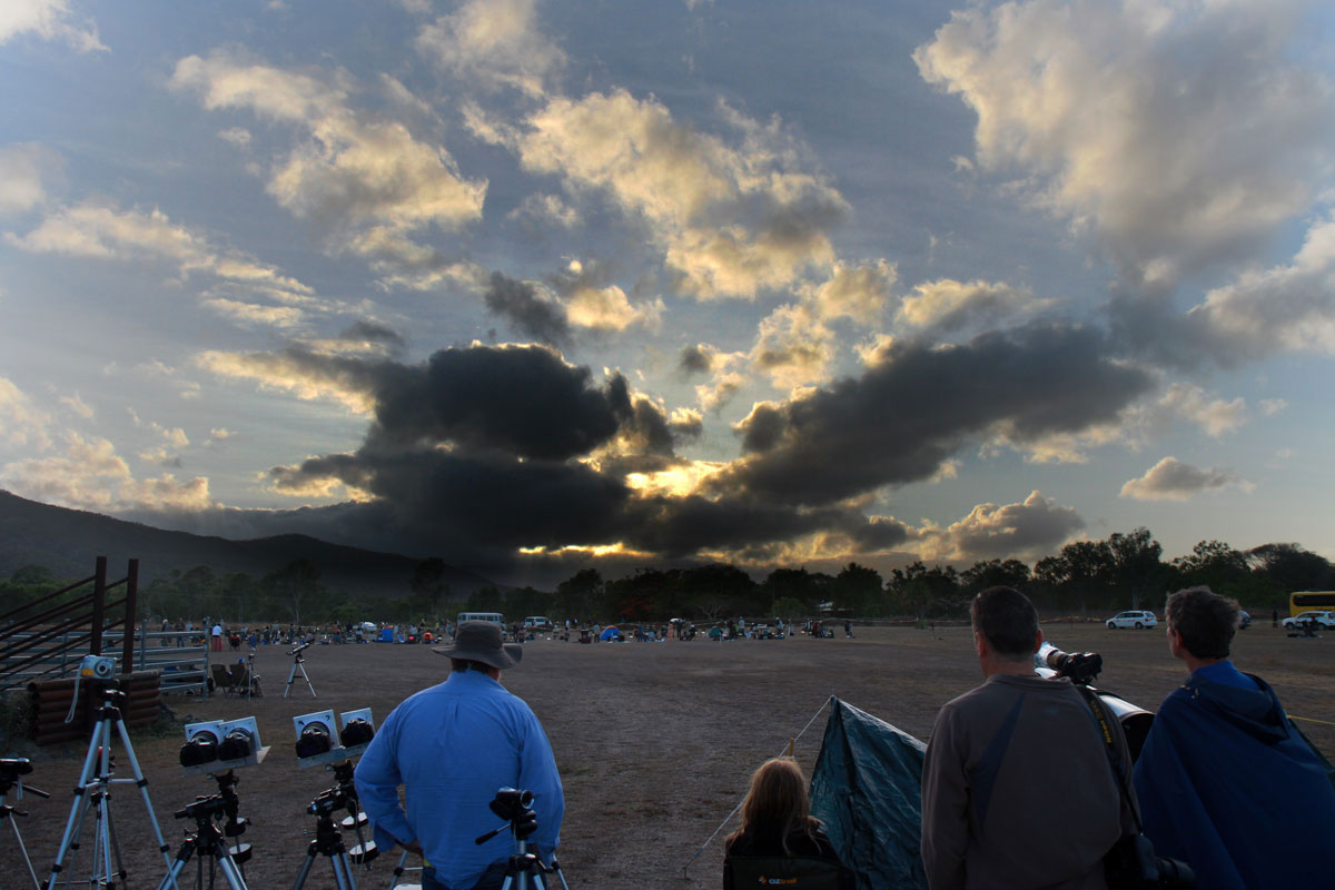 The sun rises through the clouds