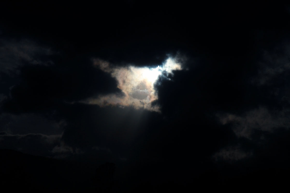 The sun shines through a hole in the clouds