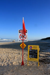 Beach closed sign on Main Beach