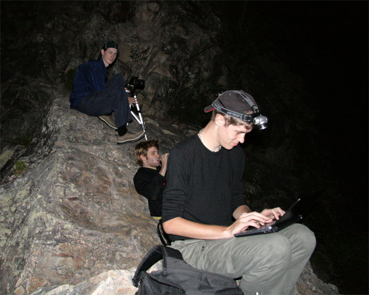 Clint checking the weather online while on Mount Tibrogargan