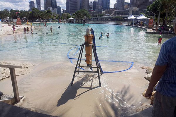 Dredging sand from the larger peeing pool