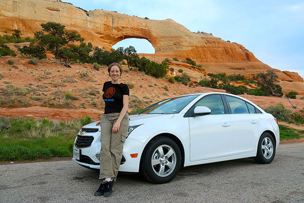 Bronwen, our hire car, and the first arch on the way into Moab