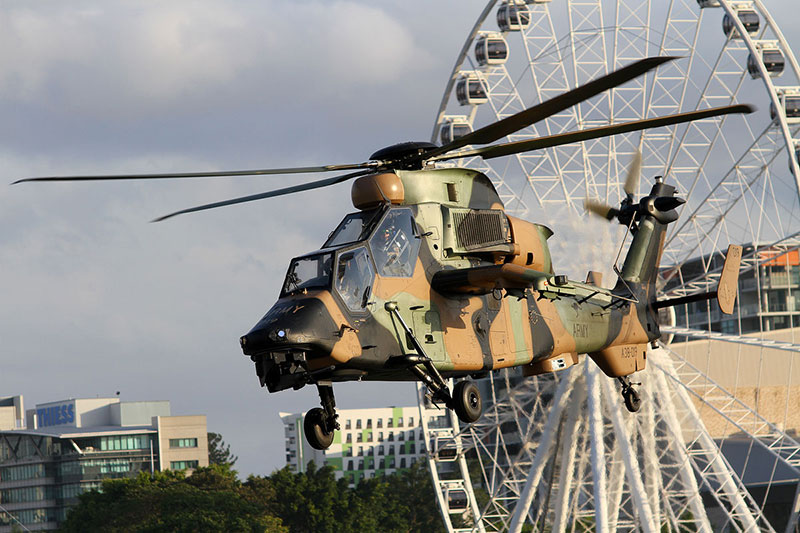 A helicopter in front of the Wheel of Brisbane
