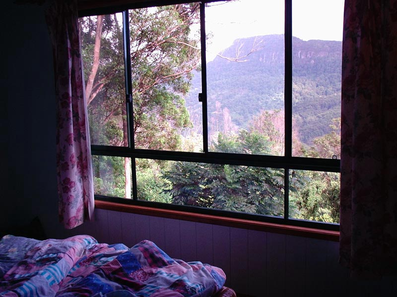The upstairs bedroom, with views over the valley and to Mt Warning in the distance.