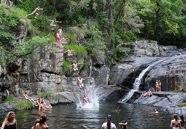 Jumping from rocks at Cedar Creek Falls