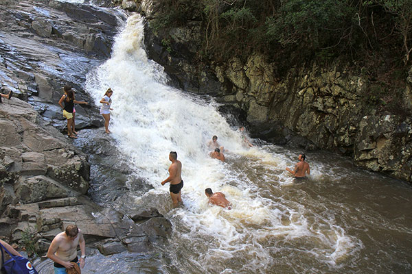 People playing in the waterfall
