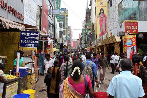 An upmarket shopping district in Chennai, complete with rubbish, dirt & mud puddles in the unpaved road