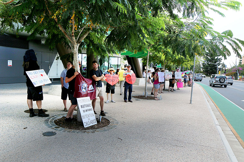 People begin to gather to protest at the vigil