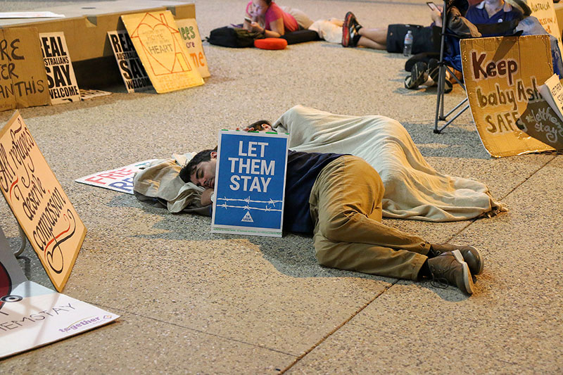 People sleep at the Vigil for Baby Asha