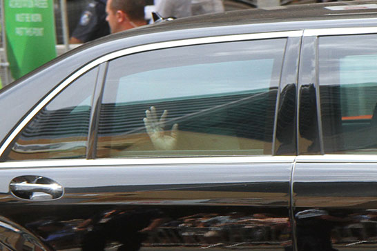 Putin waves goodbye as he heads towards the airport