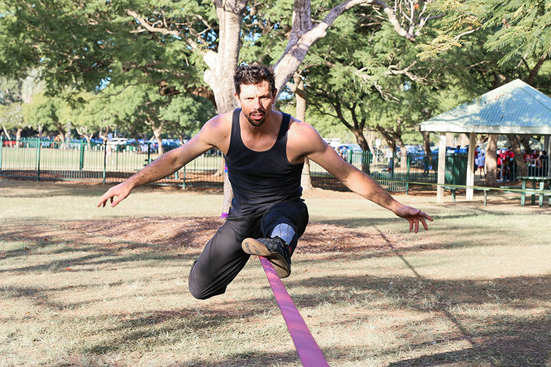 A man balances on a string